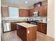 Spacious kitchen with island, stainless steel appliances, and granite countertops at 5179 Silica Chalk Ave, Las Vegas, NV 89115