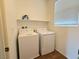 Bright laundry room, features washer and dryer, and ample shelf space at 5179 Silica Chalk Ave, Las Vegas, NV 89115