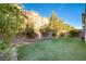 Landscaped backyard with artificial turf and a low retaining wall at 3164 Rowan Brook Ave, Henderson, NV 89052