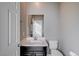 Clean bathroom with dark vanity, toilet and mirror at 3164 Rowan Brook Ave, Henderson, NV 89052