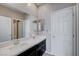 Double vanity bathroom with a large mirror and dark brown cabinets at 3164 Rowan Brook Ave, Henderson, NV 89052