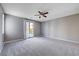 Spacious bedroom with carpet, ceiling fan and balcony access at 3164 Rowan Brook Ave, Henderson, NV 89052