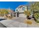 Two-story house with gray siding, gray garage door, and landscaped front yard at 3164 Rowan Brook Ave, Henderson, NV 89052