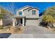Two-story house with gray siding, gray garage door, and landscaped front yard at 3164 Rowan Brook Ave, Henderson, NV 89052