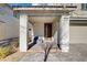 Covered porch with gray columns, brown door and gray pavers at 3164 Rowan Brook Ave, Henderson, NV 89052