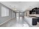 Open kitchen with dark cabinetry, granite island, and gray tile floor at 3164 Rowan Brook Ave, Henderson, NV 89052