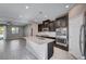 Open kitchen with dark cabinets, granite countertops and stainless steel appliances at 3164 Rowan Brook Ave, Henderson, NV 89052