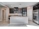 Island kitchen with dark cabinets and granite countertops at 3164 Rowan Brook Ave, Henderson, NV 89052