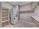 Laundry room with washer, dryer, shelving, and hanging rods at 3164 Rowan Brook Ave, Henderson, NV 89052