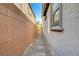 Side yard access with a brick pathway between homes at 3164 Rowan Brook Ave, Henderson, NV 89052
