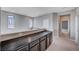 Upper hallway with dark cabinets and access to bedrooms at 3164 Rowan Brook Ave, Henderson, NV 89052