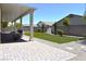 Spacious backyard features an extended covered patio, artificial turf, fountain, and desert landscaping at 7047 Noble Flair Ct, Las Vegas, NV 89131