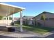 Covered patio with artificial turf and water feature in backyard at 7047 Noble Flair Ct, Las Vegas, NV 89131