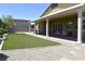 Well-maintained backyard with artificial turf, rock landscaping and covered patio with seating at 7047 Noble Flair Ct, Las Vegas, NV 89131
