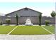 Beautiful backyard featuring artificial turf bordered by gravel, and a decorative fountain centerpiece at 7047 Noble Flair Ct, Las Vegas, NV 89131