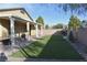 View of backyard featuring covered patio and artificial turf at 7047 Noble Flair Ct, Las Vegas, NV 89131