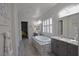 Luxurious bathroom with a standalone tub, granite countertops, and stylish fixtures at 7047 Noble Flair Ct, Las Vegas, NV 89131