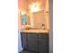 Elegant bathroom vanity featuring granite countertops and grey cabinets at 7047 Noble Flair Ct, Las Vegas, NV 89131