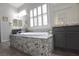 Elegant bathroom featuring a granite tub surround, dual sinks, and modern design at 7047 Noble Flair Ct, Las Vegas, NV 89131