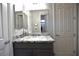 Bathroom featuring a gray vanity with granite countertop and modern mirror at 7047 Noble Flair Ct, Las Vegas, NV 89131