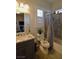 Bathroom with a modern single sink vanity, plantation shutters, and shower-tub combo at 7047 Noble Flair Ct, Las Vegas, NV 89131