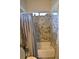 Clean bathroom featuring granite shower surround and chrome shower head at 7047 Noble Flair Ct, Las Vegas, NV 89131