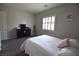 Bedroom with carpet, white linens, a dark dresser, and a shuttered window at 7047 Noble Flair Ct, Las Vegas, NV 89131