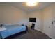 Simple bedroom design with basic decor, carpet floors, and a mounted television at 7047 Noble Flair Ct, Las Vegas, NV 89131