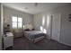 Cozy bedroom featuring a stylish bed, desk, and window with plantation shutters at 7047 Noble Flair Ct, Las Vegas, NV 89131