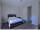 Well-lit bedroom features a queen-sized bed, soft carpet, and a decorative mirror at 7047 Noble Flair Ct, Las Vegas, NV 89131