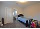 Comfortable bedroom with neutral walls, dark-wood bed frame, and carpet flooring at 7047 Noble Flair Ct, Las Vegas, NV 89131