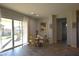 Cozy dining area featuring wood floors, glass doors, and backyard views at 7047 Noble Flair Ct, Las Vegas, NV 89131