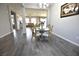 Cozy dining room with stylish furnishings and an open view to the living room at 7047 Noble Flair Ct, Las Vegas, NV 89131