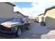 View of side driveway, with parked truck and house in background at 7047 Noble Flair Ct, Las Vegas, NV 89131