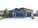 Charming home featuring a stone facade, two-car garage, and manicured front yard at 7047 Noble Flair Ct, Las Vegas, NV 89131