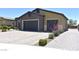 A beautiful home with a stone facade, paver driveway, and a two-car garage, bathed in sunlight at 7047 Noble Flair Ct, Las Vegas, NV 89131