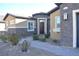 Close-up of home's entry featuring stone facade, complemented by a well-maintained garden at 7047 Noble Flair Ct, Las Vegas, NV 89131