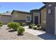 Attractive single-story home showcasing stone accents, a brick walkway, and manicured landscaping at 7047 Noble Flair Ct, Las Vegas, NV 89131