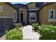 A single-story home with stone accents, an arched entryway, and a brick walkway lined with bushes at 7047 Noble Flair Ct, Las Vegas, NV 89131