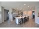 Spacious kitchen with stainless steel appliances, island with bar seating, and modern lighting at 7047 Noble Flair Ct, Las Vegas, NV 89131