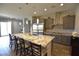Kitchen features a granite island with seating, stainless steel appliances, and plenty of counter space at 7047 Noble Flair Ct, Las Vegas, NV 89131