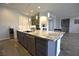 Kitchen island featuring granite countertops, stainless steel appliances, and stylish pendant lighting at 7047 Noble Flair Ct, Las Vegas, NV 89131