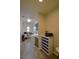 Bright laundry room with a washer, dryer, grey cabinets, and wood-style tile flooring at 7047 Noble Flair Ct, Las Vegas, NV 89131