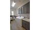 Bright laundry room features a washer, dryer, sink, grey cabinets, and wood-style tile flooring at 7047 Noble Flair Ct, Las Vegas, NV 89131