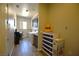 Bright laundry room with wood-look tile flooring, washer, dryer, and storage cabinets at 7047 Noble Flair Ct, Las Vegas, NV 89131
