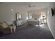 Spacious main bedroom with plush carpeting, a ceiling fan, and large windows at 7047 Noble Flair Ct, Las Vegas, NV 89131