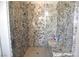 Stylish shower featuring granite walls, a built-in bench, and a clear glass door at 7047 Noble Flair Ct, Las Vegas, NV 89131