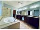 Large bathroom with double sinks, soaking tub, and shower at 11416 Belmont Lake Dr # 102, Las Vegas, NV 89135