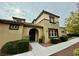 Tan two-story home with dark brown door and landscaping at 11416 Belmont Lake Dr # 102, Las Vegas, NV 89135