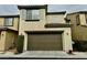 Attached garage with brown door and address number at 11416 Belmont Lake Dr # 102, Las Vegas, NV 89135